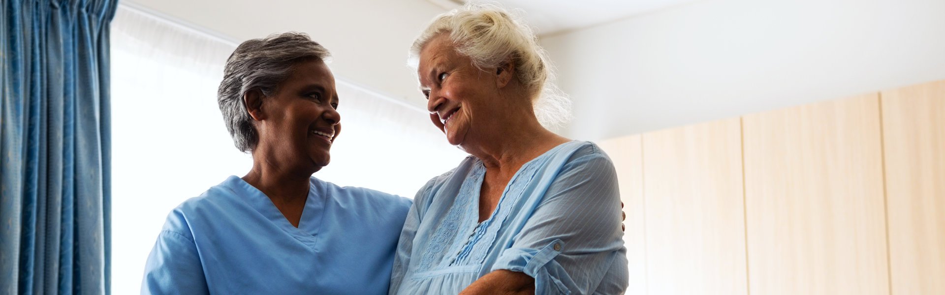 aide assisting an elderly woman