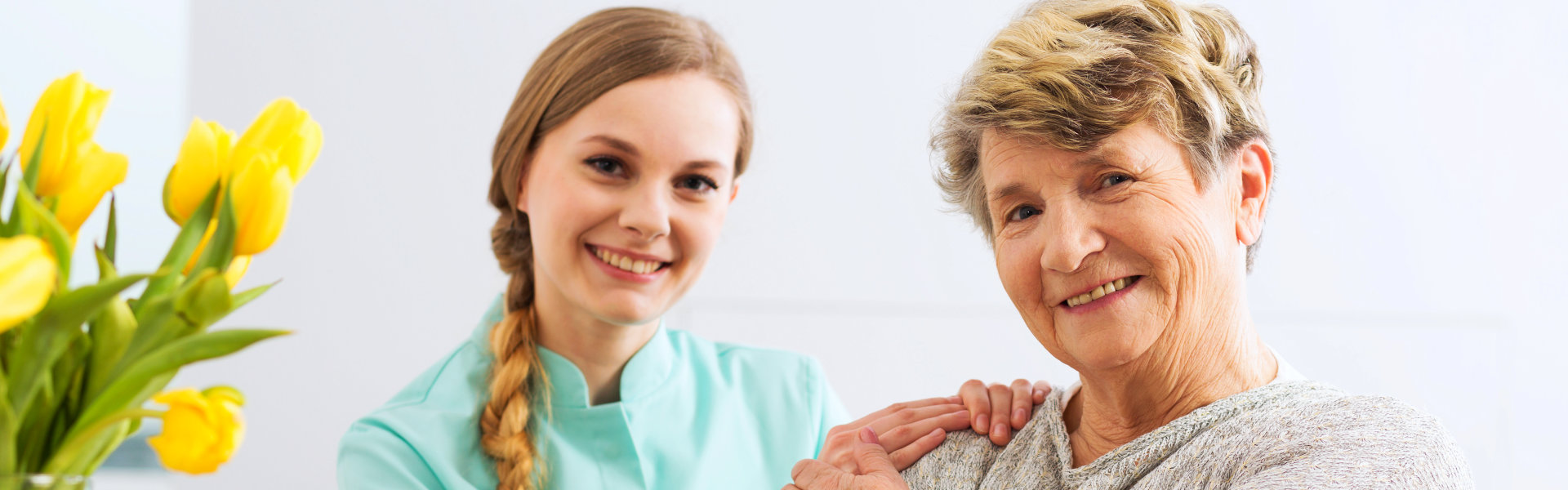 aide and elderly woman smiling