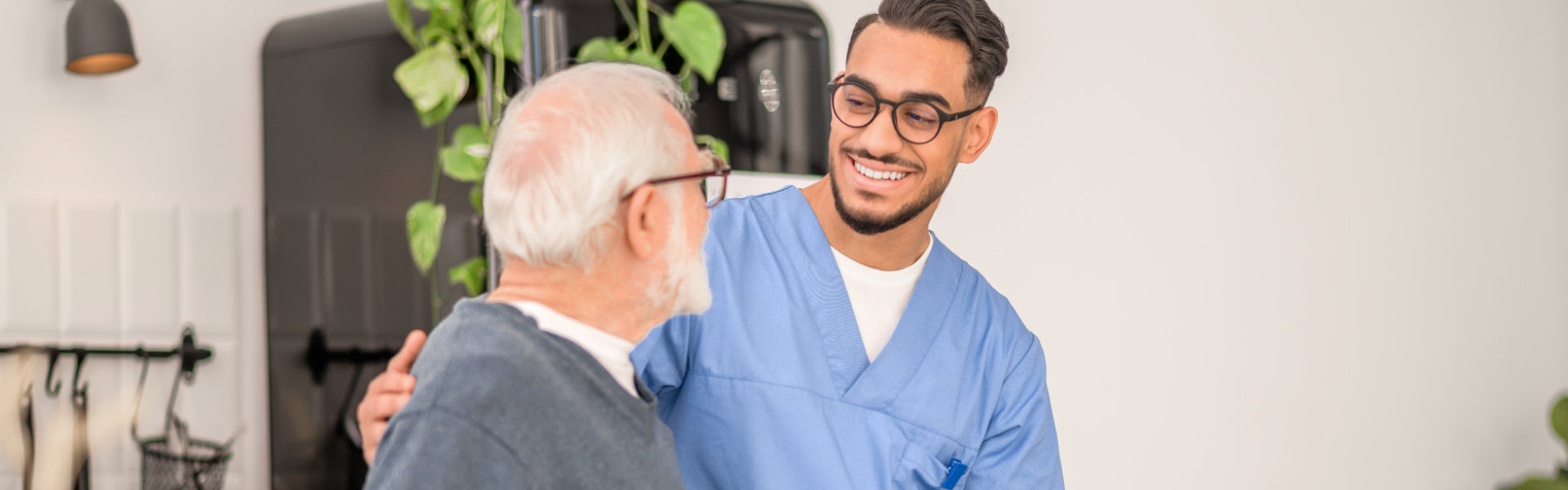 elderly man and aide talking