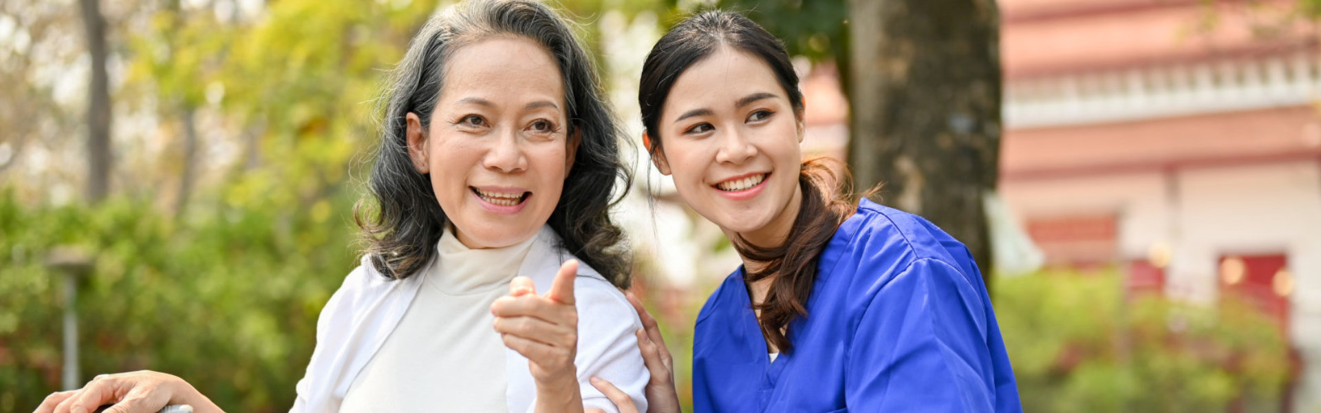 aide and elderly woman smiling